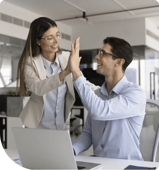 Colleagues celebrating success in a modern office.